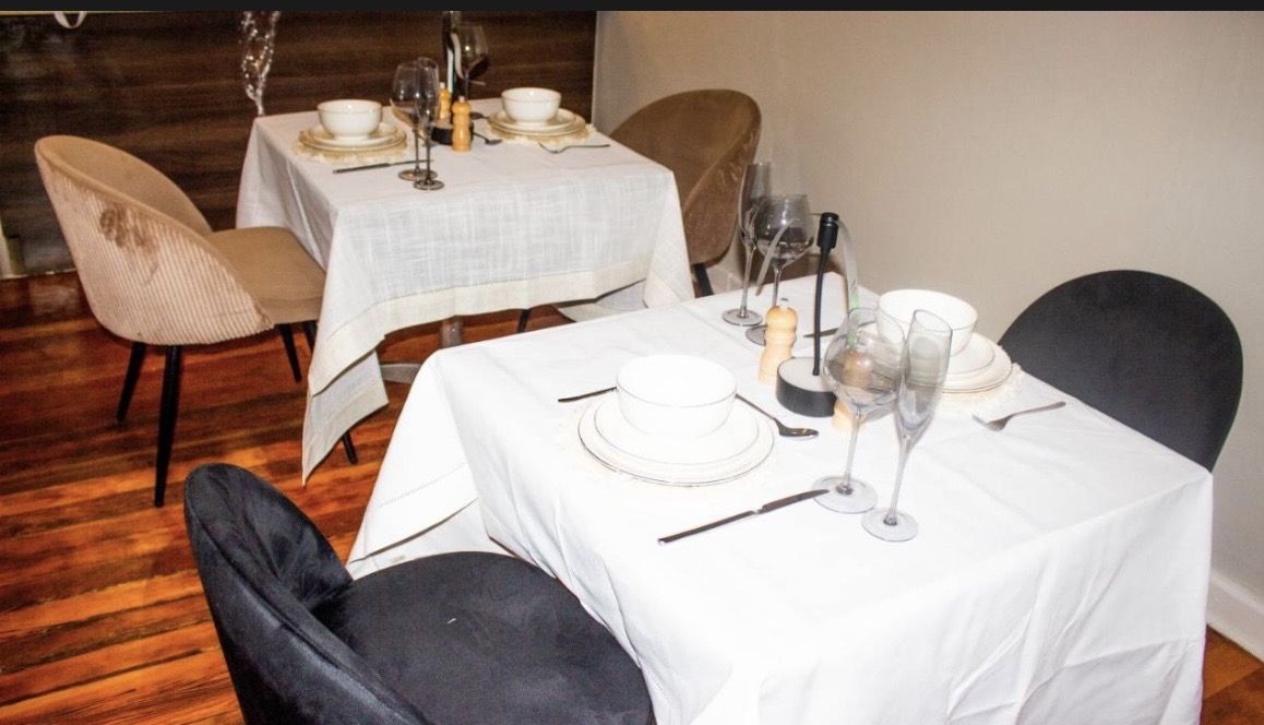 Dining area with set tables at Phela Guesthouse
